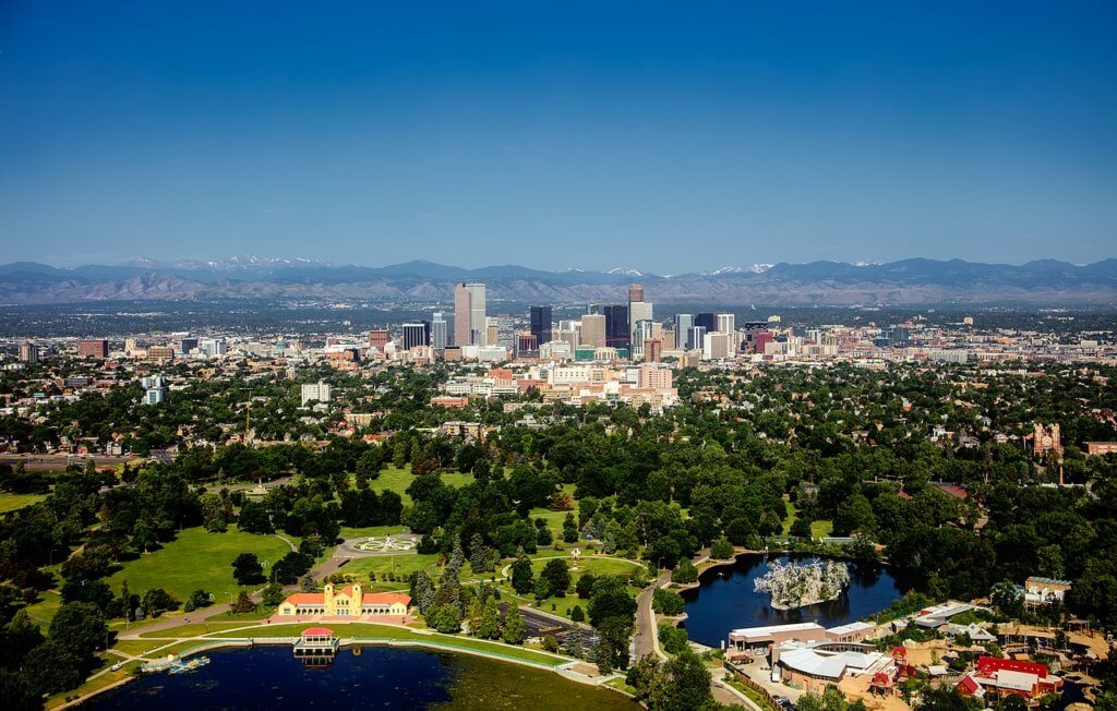 The denver skyline with the Rocky Mountains behind it
